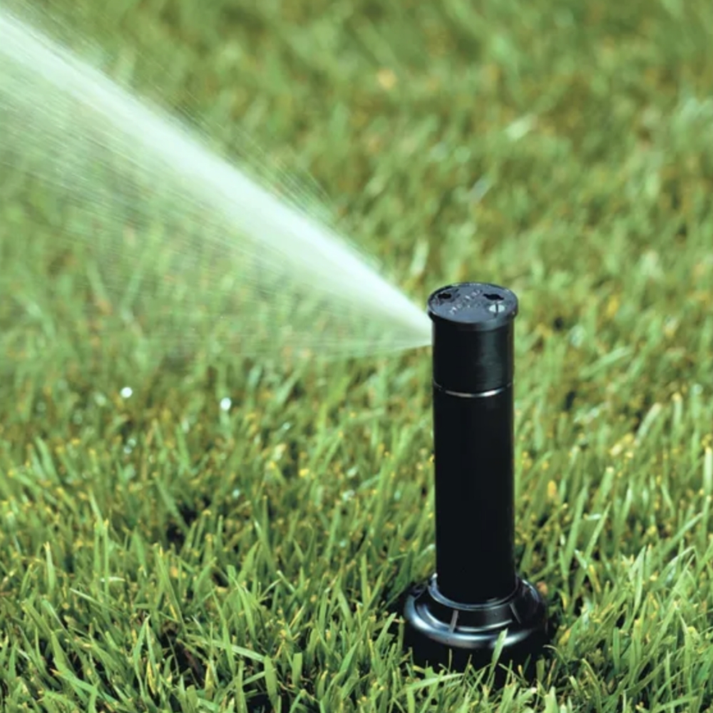 a sprinkler spraying water on grass